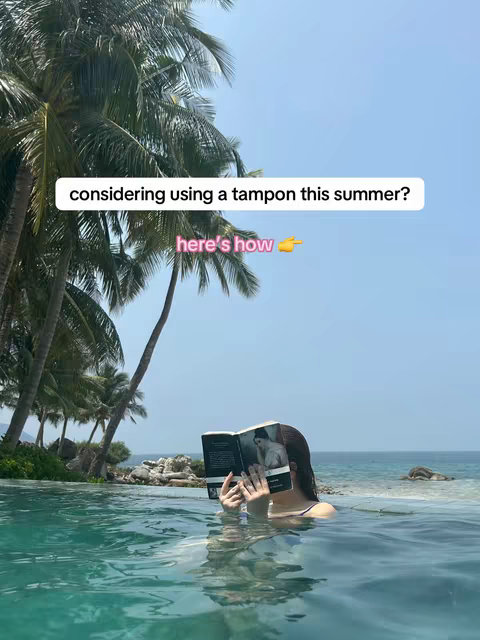 The cover image features a person in a pool with scenic views of palm trees and the ocean. The person is reading a book while partially submerged in the water.