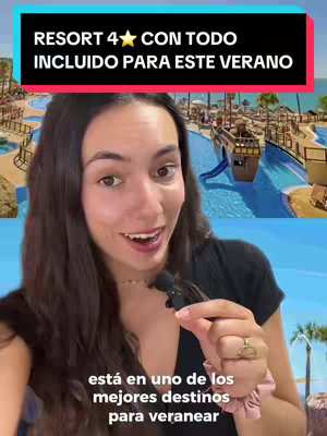 A woman with long dark hair looks directly at the camera with a smiling expression. She is holding a microphone. The background shows a sunny resort with a waterpark, a ship-shaped feature, and palm trees. A text overlay across the top reads 'RESORT 4 CON TODO INCLUIDO PARA ESTE VERANO' with additional text near the bottom.
