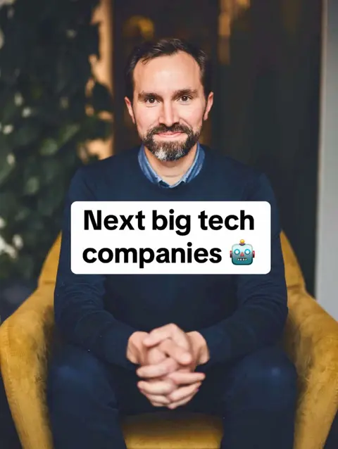 A man in a navy blue sweater sits in a yellow armchair against a blurred background. A white rectangle overlay displays the text 'Next big tech companies' with a robot emoji.