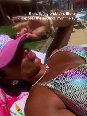 A woman in a bikini and sunhat is lying down, with text overlaid indicating her problems disappear in the sun. The image is well-lit, with a focus on her face and upper body.