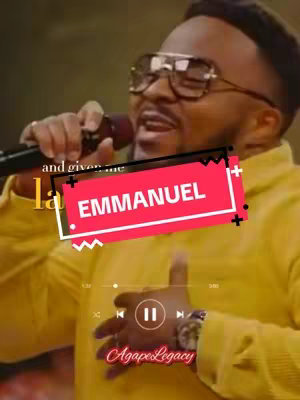 The cover image showcases a man with glasses holding a microphone. The background suggests a stage or performance setting, with soft lighting and blurred details. Overlayed is a red text box with the word 'EMMANUEL,' and the 'AgapeLegacy' branding is at the bottom.
