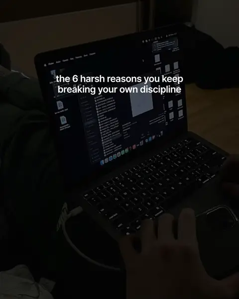 The image shows a laptop on a person's lap, with the screen displaying code files. Text overlayed on the screen reads, 'the 6 harsh reasons you keep breaking your own discipline.' The scene is dimly lit, focusing on the laptop setup and hands of the person using it.