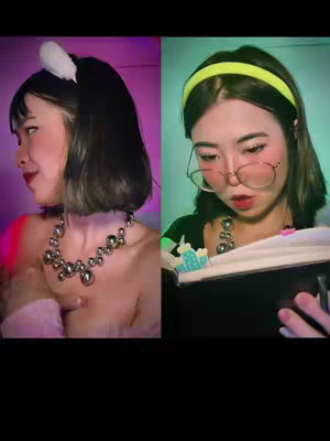 The cover image is split into two vertical sections. On the left, a person with dark hair wears a white fluffy ear headband and a prominent silver necklace. They are turned at an angle, with one arm up near their face with visible blush. The background is a gradient of purple and pink. The right side features a different person wearing glasses and a yellow headband while reading a book. Green lighting serves as the backdrop.