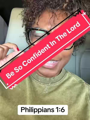 A woman with curly hair, wearing glasses and a green shirt, smiles. A red banner with the words 'Be So Confident In The Lord' diagonally crosses the frame. The text 'Philippians 1:6' is in a white box at the bottom.