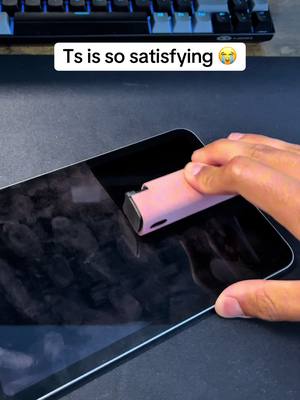 The cover image shows a person's hand cleaning a tablet screen with a pink cleaning tool. In the background, a keyboard is visible.