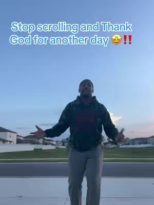 A man stands outdoors, arms open wide in a gesture of gratitude, against a backdrop of a blue sky and suburban houses. Text overlays the image.
