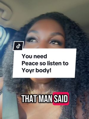 A selfie-style shot of a woman looking up and slightly to the right, possibly in a car. She has dark, curly hair and is wearing a gold chain. Overlayed on the image is a white box with text and a red box at the bottom with white text. The background appears blurred.