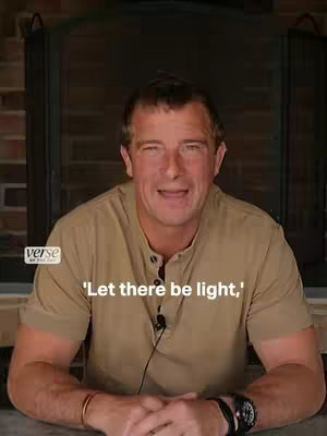 A man with short, dark hair and a tan button-down shirt is centered in the frame, against a backdrop of a dark fireplace and brick. The man is smiling and the overlaying text states "'Let there be light,'". Below the man is the logo of Verse.