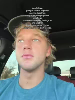 A selfie-style shot taken from inside a car, focusing on a young man's face. He has blonde hair and is wearing a blue shirt. Text overlays are present, listing relationship-oriented sentiments.