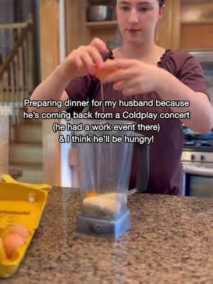 A woman in a maroon top is in a kitchen, preparing food. She is holding an egg and cracking it, letting the contents fall into a blender. In the background, a yellow egg carton and kitchen shelves are visible. Text overlays the image.