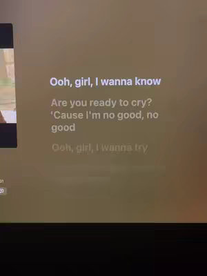 The cover image displays song lyrics overlaid on a muted brown background. The text is white and centered, featuring phrases and questions from a song.