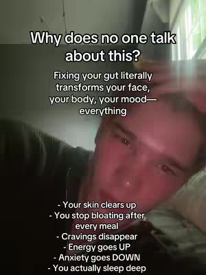 A close-up selfie showing a young man lying down, with text overlays on the image. The man appears to be in a bedroom setting, with soft lighting.