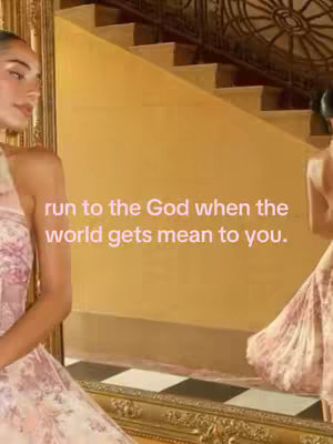 The cover image features a woman in a pink dress, reflected in a mirror. Behind her is a staircase with golden walls. Text overlays read, "run to the God when the world gets mean to you." The overall composition conveys a sense of elegance and faith.