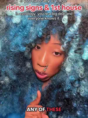 A close-up shot of a person with a dramatic hairstyle and face. The person has large, expressive eyes and is giving a slightly mysterious look, pointing their finger up. The text overlays describe the topic of the video, which is astrology. A colorful wig frames the face.