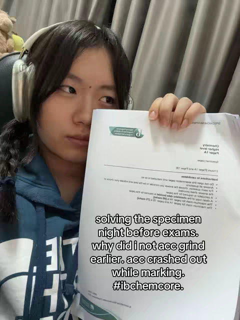 The cover image shows a young woman with dark hair and headphones, holding a piece of paper with printed text. The woman is looking down at the paper with a serious expression. Overlaid text is visible, describing exam prep and the student's experience.