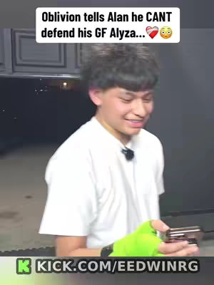 A smiling young man is centered in the frame against a blurred or unknown background. He is wearing a white t-shirt and has a small microphone attached to his shirt. His right arm is bent, and he is holding a phone in his hand. The cover image has text overlayed at the top. In the bottom corner is a branded logo.