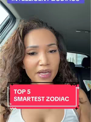 A woman with long, wavy brown hair is seated inside a car. She has light skin, is wearing makeup, and is talking. A red banner with white text overlay stating "TOP 5 SMARTZET ZODIAC" is centered in the lower portion of the frame.