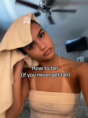 A woman is shown looking at the camera with a towel on her head and a bandeau top, with the text overlayed on the picture.