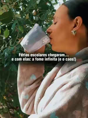A woman is seen outdoors, near some foliage, holding a cup and taking a sip. Overlayed text describing school vacations and related issues of hunger.