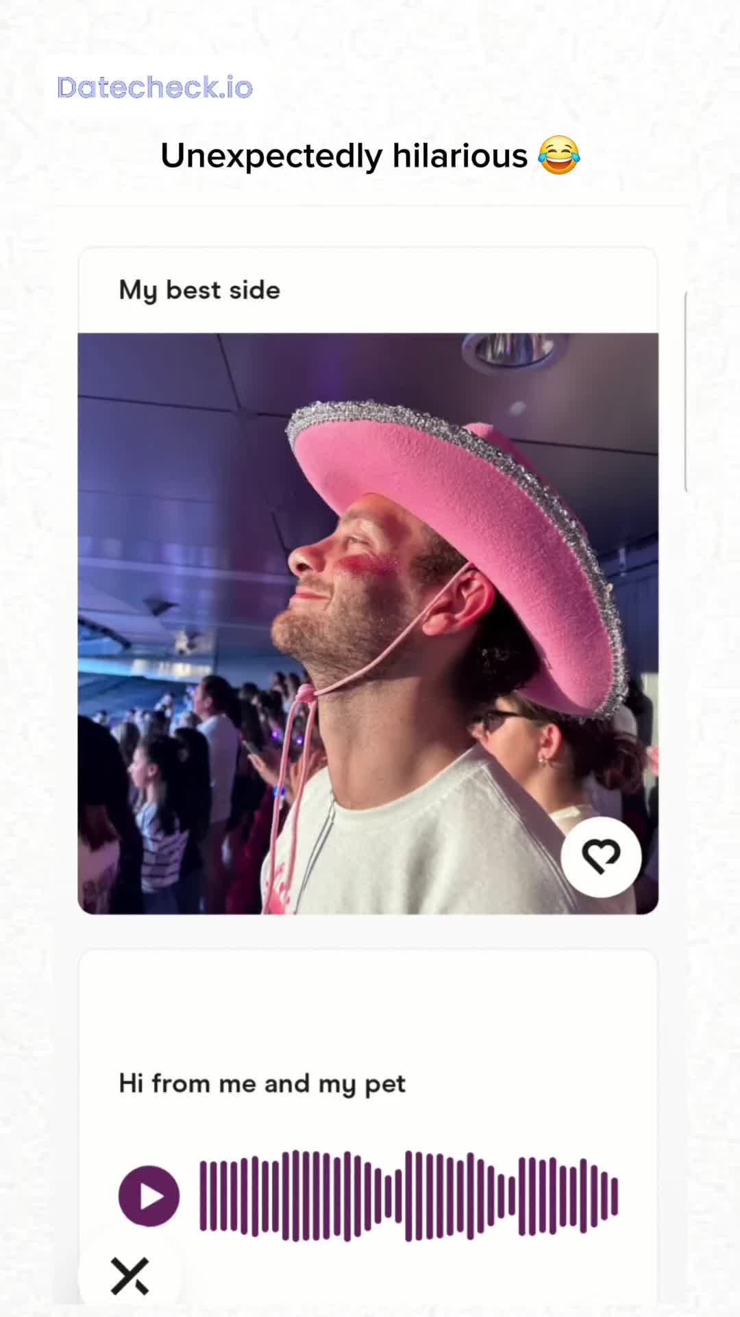 A selfie-style screenshot from a dating app profile. The main element is a man with a smile, wearing a pink cowboy hat, and looking up. In the background, there’s a crowd of people, suggesting a social setting like a party or event. Below, there's an interface element suggesting a voice message.