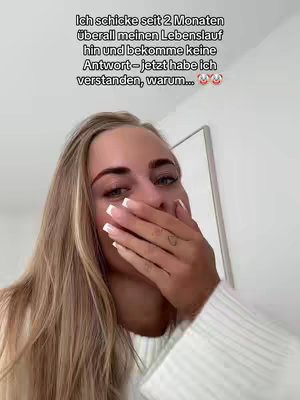 The cover image features a close-up of a fair-skinned woman covering her mouth with her hand, next to text at the top. The woman has long blonde hair, is wearing a white top and has visible eye makeup. The background is blurred, suggesting an interior setting.