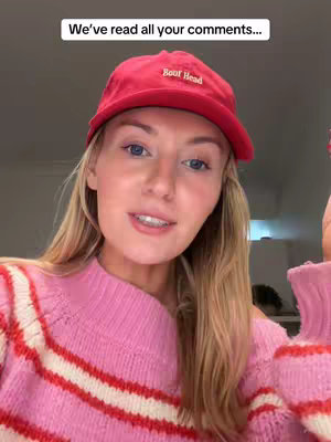 The cover image features a woman in a close-up shot, wearing a red baseball cap that says "Boor Head", a pink knitted sweater with red and white stripes, and her blonde hair is flowing loosely. The background is a blurred interior, with the focus on her face and upper body. The lighting seems natural, and the composition is simple, emphasizing the woman's expression.