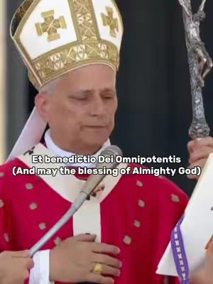 A medium shot shows a man dressed in religious attire, holding a microphone and a religious artifact. The background is blurred, but it appears to be an outdoor setting.