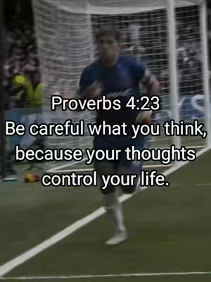 A man in a blue and black uniform is running on a green soccer field. Text overlays in a white font. The background includes a net and the audience.