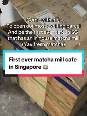 The cover image features a wooden crate with text overlays in a rectangular box. The text announces the opening of the first matcha mill cafe in Singapore. The crate is brown with green and blue bands and markings.