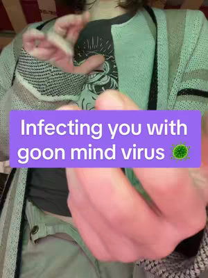 The cover image features a person with their hands in front of them, a lilac rectangle containing text overlays them. The person is wearing a black shirt with a white drawing on it and a green cardigan. The background appears to be blurry.
