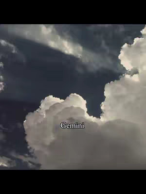 A dark, dramatic image of a cloudy sky. White, fluffy clouds are prominent against a backdrop of darker clouds. The word "Gemini" is placed in the center of the image.