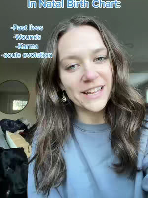 A woman with long brown hair is centered in the frame, smiling and speaking. Behind her are muted-tone interiors including a round mirror. Text in a dynamic blue font is overlaid on the image.
