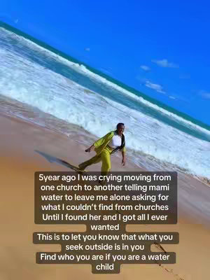A woman in a yellow suit walks towards the camera on a sandy beach. Behind her, the waves roll in under a bright blue sky. A text overlay sits in the bottom third of the image. The text is in a dark box.