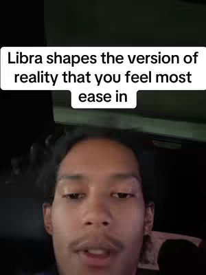A selfie-style video with a man as the focus. He is centered in the frame, with a text overlay in a white box above his head. The background is dark, possibly the interior of a car. The man has short, dark hair, a mustache, and is looking directly at the camera.