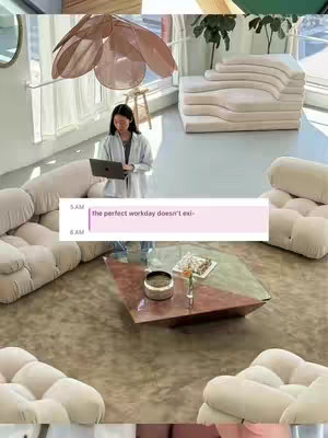 A woman in a light-colored outfit works on a laptop in a modern, well-lit space. The room has a soft, inviting aesthetic with curved furniture and a decorative ceiling light. A text overlay suggests this is a guide for Google Calendar use.