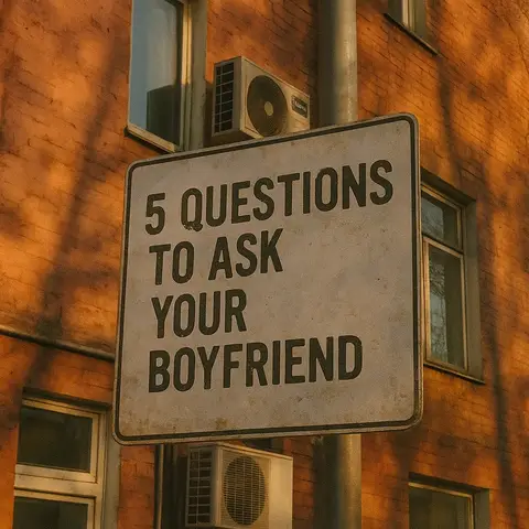 The image features a weathered street sign with the text "5 QUESTIONS TO ASK YOUR BOYFRIEND" in bold, black font. The sign is rectangular and set against a blurred background of a brick building with air conditioning units. The lighting suggests a sunny day, casting shadows and giving the image a warm, inviting tone.
