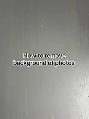 The cover image features a vertical composition in a light gray tone. The text overlay, centered, reads 'How to remove background of photos' in a simple, sans-serif font. The background appears plain with a slightly textured appearance.