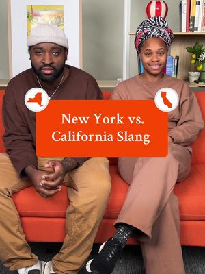 Two people, a man and a woman, are seated on a bright orange couch. The man on the left is wearing a brown beanie, a brown shirt, and tan pants. The woman on the right is wearing a head wrap, a sweater also in brown tones and brown pants. Both are looking ahead, with a brown background. The upper part of the image includes a bookcase and some decor. A rectangular orange overlay with white text reading 'New York vs. California Slang' covers the center of the image. There are two circular icons, one with a New York outline and the other with a California outline in white.