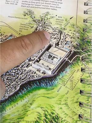 A person's finger points to a detailed map of a historical Jerusalem scene, likely from a Bible or history study book, focusing especially on the temple area.