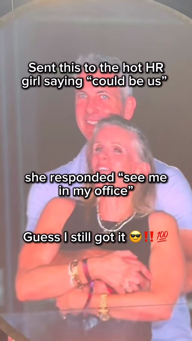 A man and woman are shown in a warm embrace, captured from the chest up, with the man positioned behind the woman. The woman has her head tilted back in laughter or surprise, with the man smiling behind her. Text overlays are present, adding context and humor to the image.