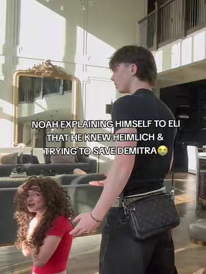 A man in a black shirt is turned towards a woman with curly hair in a red top. The man is gesturing with his hands. Text overlaid on the image.