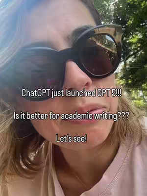 A selfie-style shot. The frame focuses on a woman's face, wearing large dark sunglasses. Text overlays are added to the image. The background shows a mix of green foliage, suggesting an outdoor setting, with the upper third of the frame is a light-colored sky or bright area.