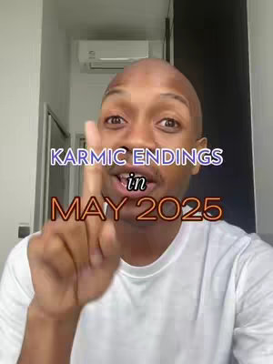 A man with a bald head is pointing his index finger up towards the overlaid text, which reads "KARMIC ENDINGS" above "in" and "MAY 2025" with a serious facial expression, in an indoor setting with a white wall and partial view of a door on the left and a dark column on the right.