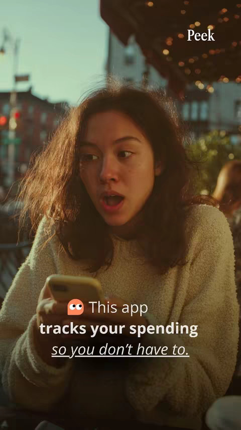 A young woman with open mouth and surprised expression looking at a smartphone, with text overlayed, with an outdoor setting and blurred background.