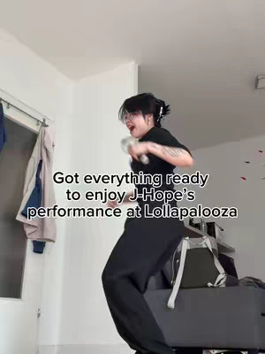 The cover image shows a person, possibly female, dancing energetically in an indoor setting. The individual wears black clothing and has dark hair styled in a bun with bangs; glasses are also worn. The background includes a wall. Text overlay is present on the image.