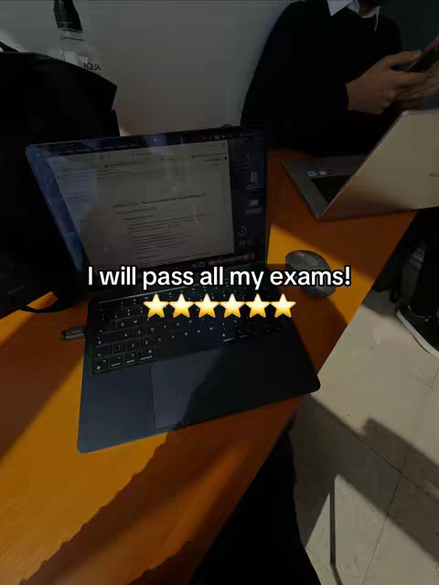 A laptop sits open on an orange desk, presumably displaying study materials. The text overlay at the bottom says "I will pass all my exams!" with five gold stars indicating success.