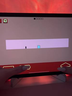 The image shows a person holding a mobile phone, displaying a game on the screen. The game features a minimalist design with a small figure and a series of blocks forming a level. The hands holding the phone are visible in the foreground, with the screen and game elements taking up the majority of the frame. The background is a gradient of red.