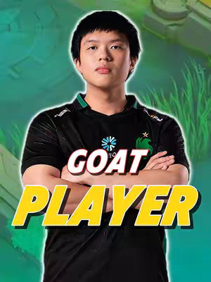 The cover image features a young man, with short, dark hair, directly facing the camera. He wears a black and green shirt and has his arms crossed. The background is a blurred graphic of a mobile game. Overlayed on the image are the words 'GOAT PLAYER' in a bold, yellow font.