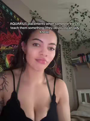 A woman with long dark hair and hoop earrings smiles towards the camera. The background includes a tapestry and plants. Text overlayed onto the image displays a caption.