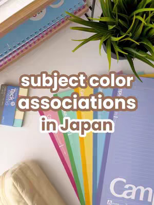 The cover image shows a bird's-eye view of a desk with colorful notebooks and stationery. The central focus is a text overlay that says 'subject color associations in Japan' in a bubble-like font.